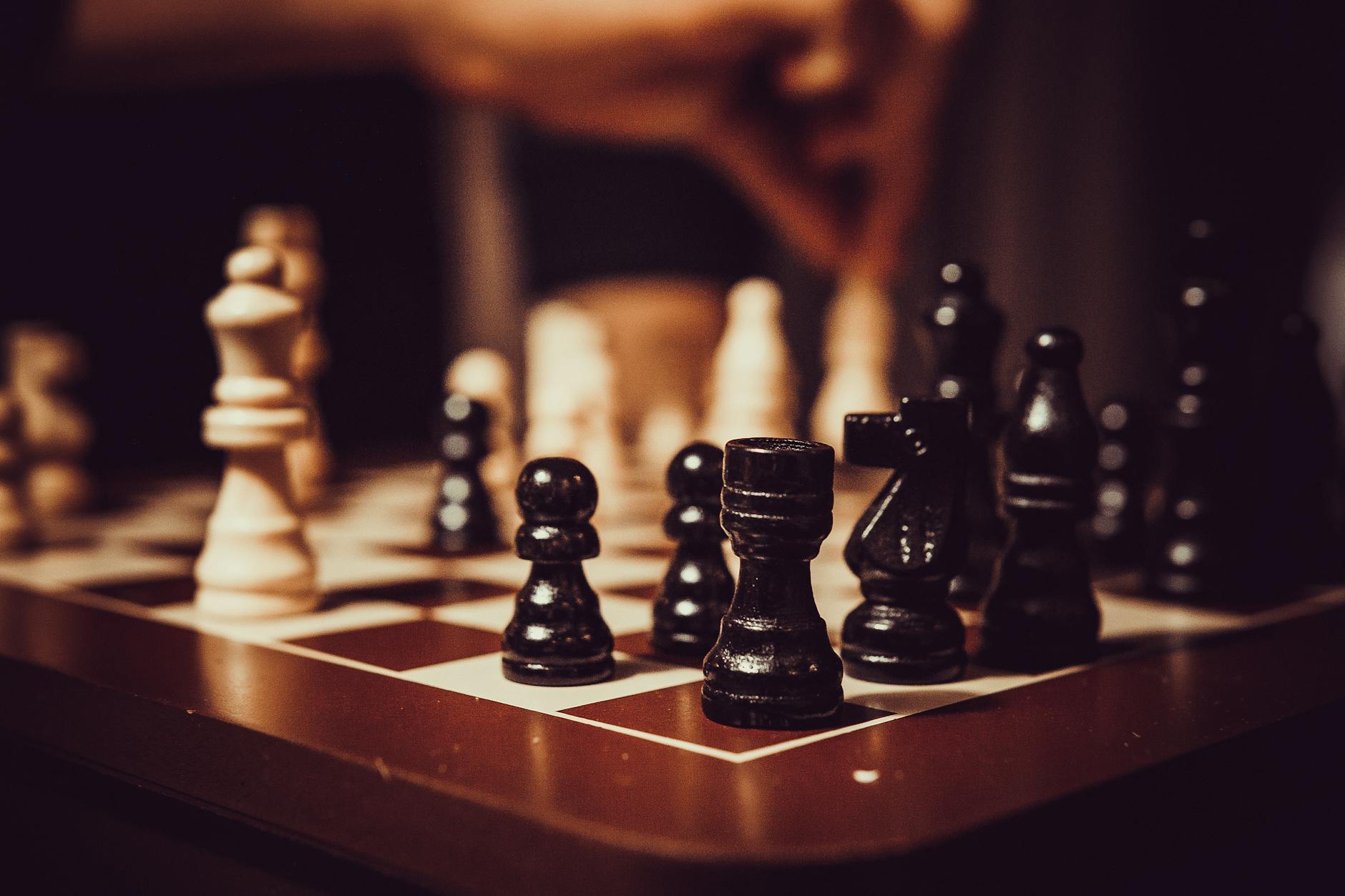 black and white chess pieces on chess board