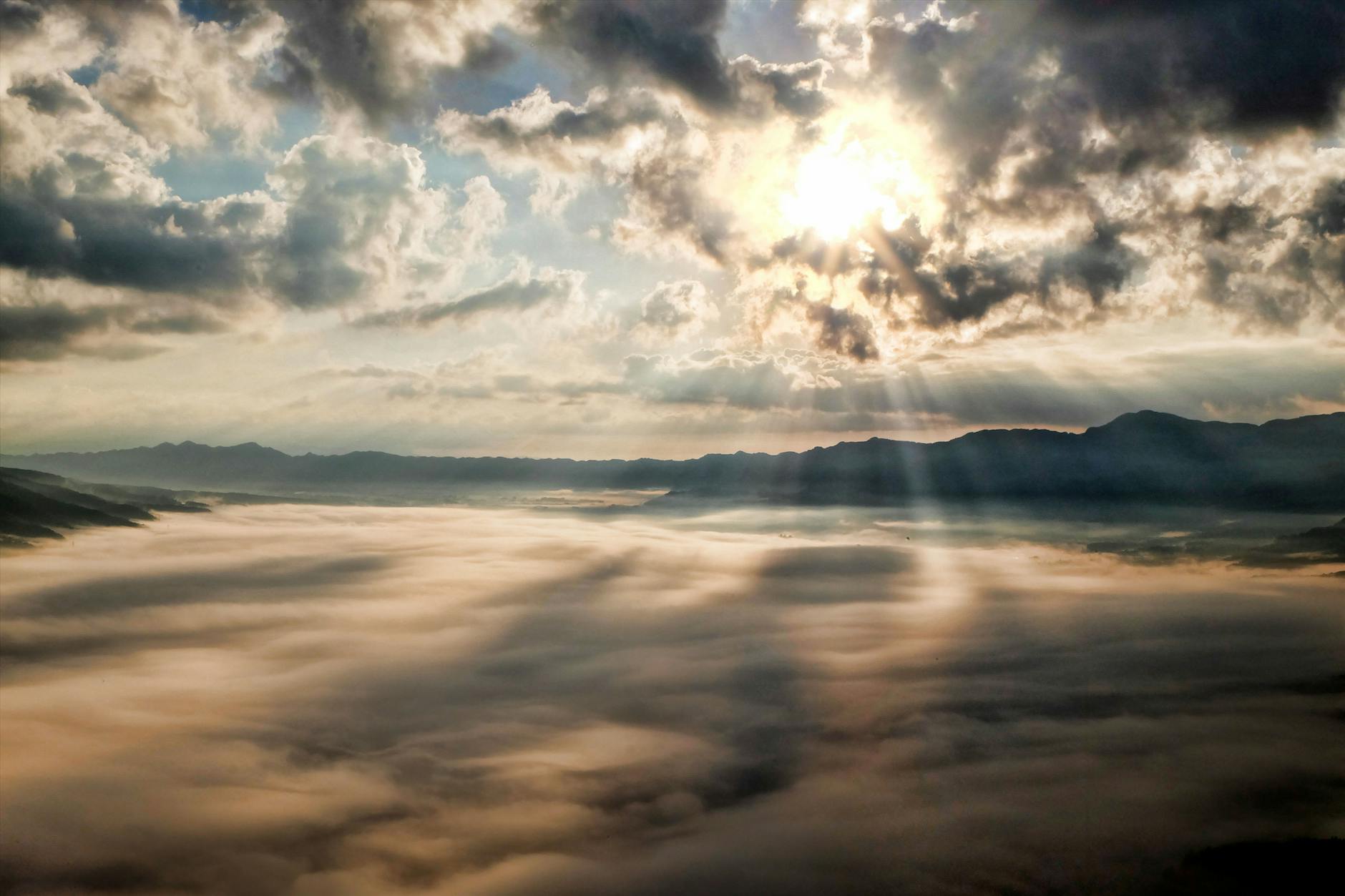 white clouds with sun piercing through it