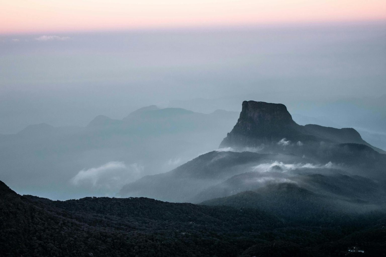 gray mountain under gloomy sky