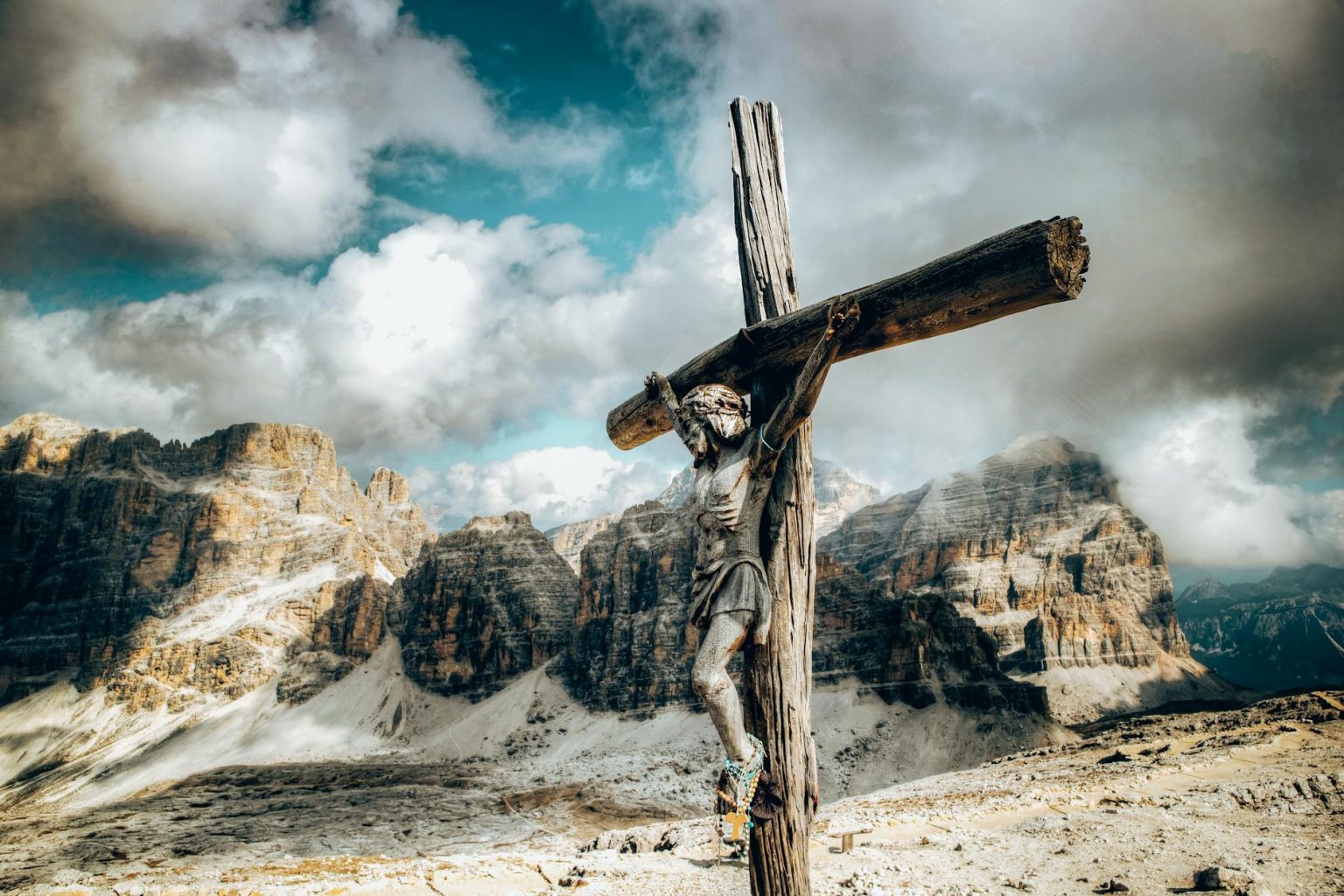 a wooden crucifix against the rock mountains